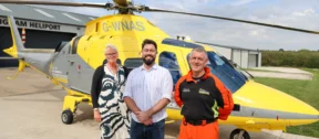 Left to right: CEO Peta Wilkinson, Adam Thompson MP and Pilot John McCallion in front of an air ambulance.