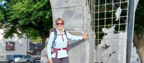 Anne Stephenson, a fundraiser, in front of the starting point monument at Minehead, Somerset.