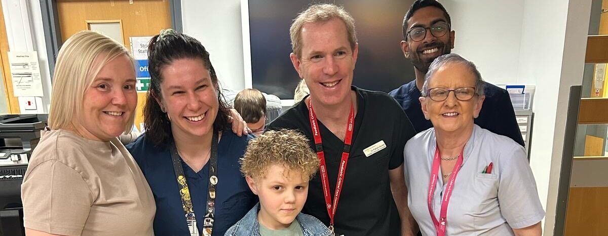 Charlie and his mum, standing with the hospital staff who supported Charlie.