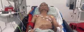 John laying in a hospital bed.