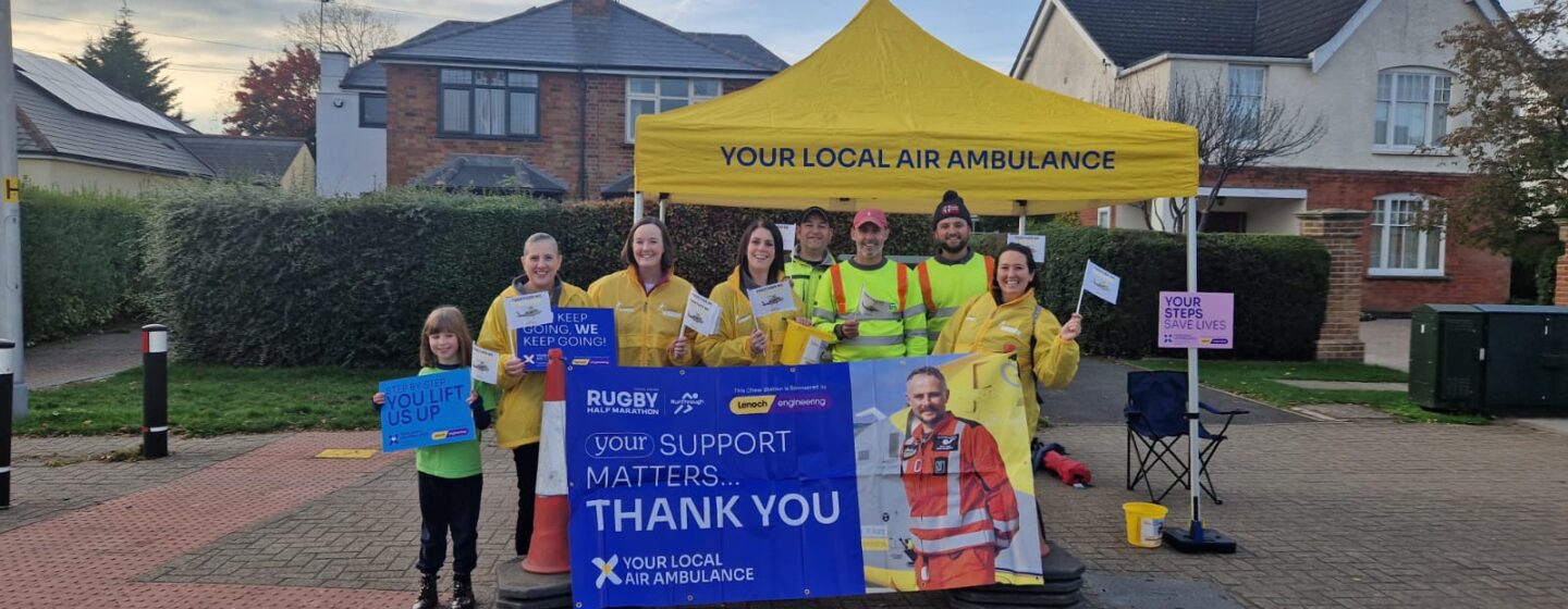Staff and volunteers at the marathon, with banners and flags.