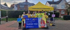 Staff and volunteers at the marathon, with banners and flags.
