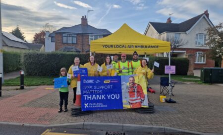 Staff and volunteers at the marathon, with banners and flags.