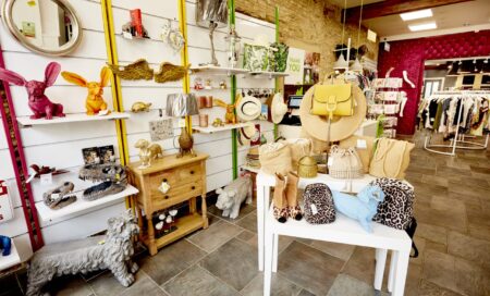 The inside of a YLAA charity shop, with shelves of accessories.