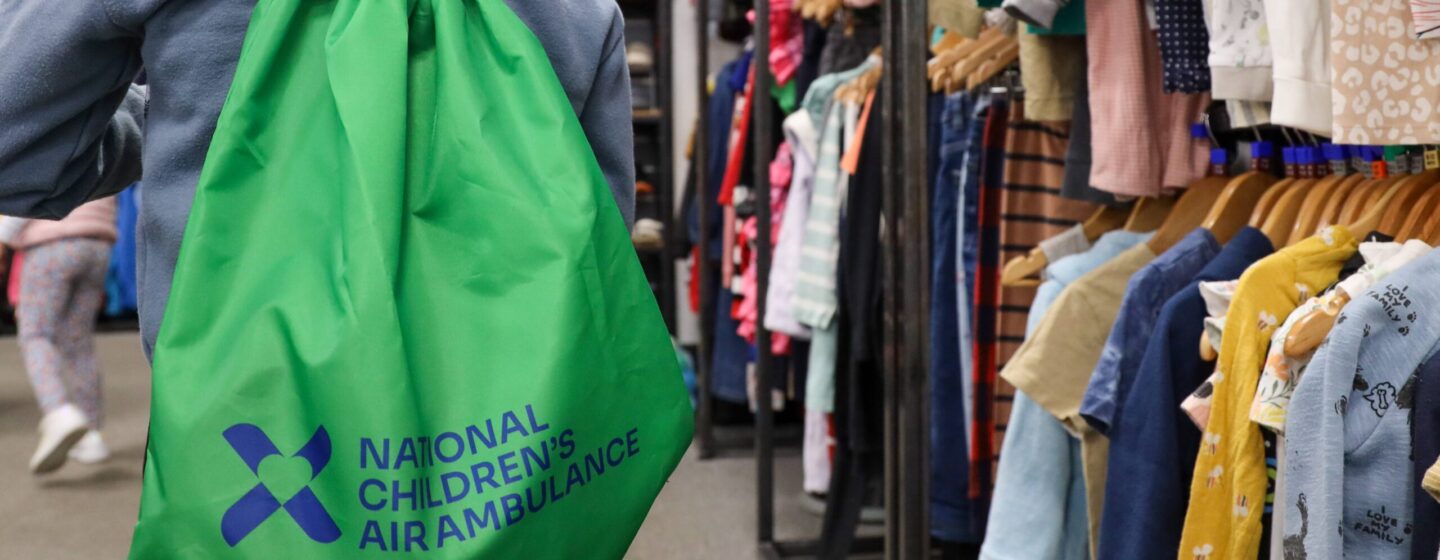 A young boy wearing one of our Sensory Borrow Bags in store