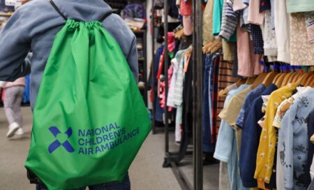 A young boy wearing one of our Sensory Borrow Bags in store