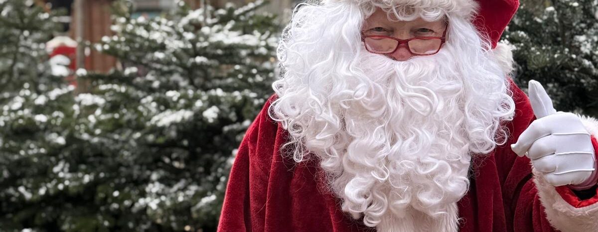 Roger dressed up as Santa with a thumbs up