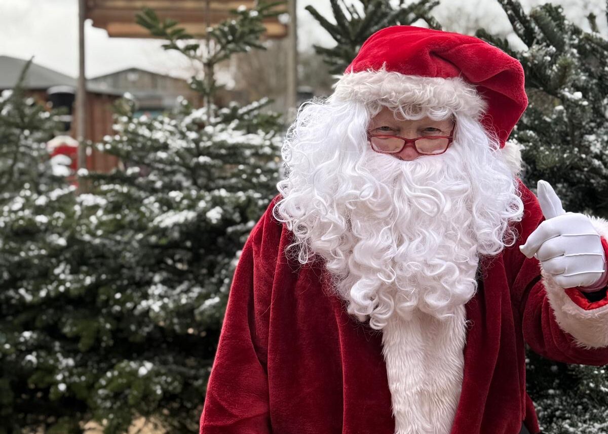 Roger dressed up as Santa with a thumbs up
