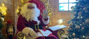 Roger dressed as Santa, sitting in his grotto.