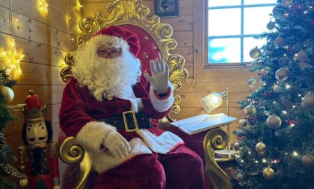 Roger dressed as Santa, sitting in his grotto.