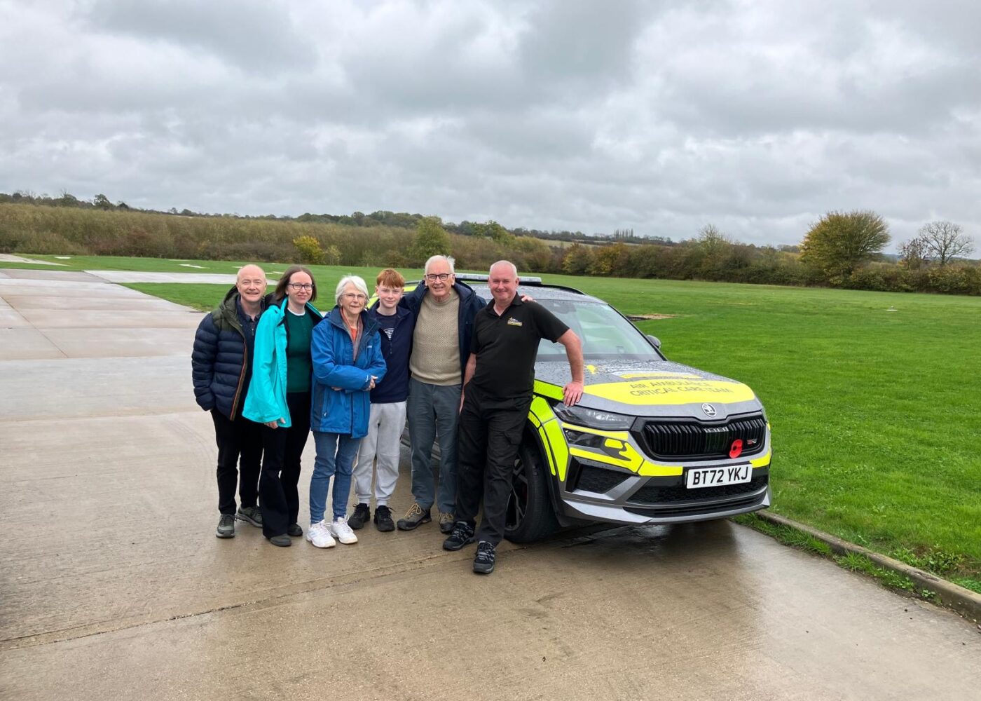 Tony Thomas and his family on a base visit, in front of one of our critical care cars.