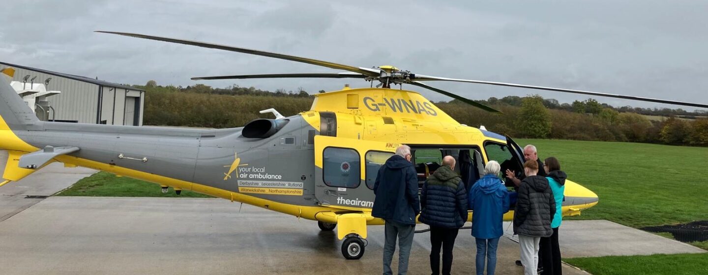 Tony Thomas and his family on a base visit, in front of our helicopter.