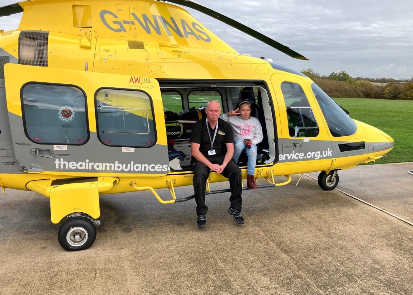 Destiny sittiing in our helicopter, on a base visit, doing a peace sign.