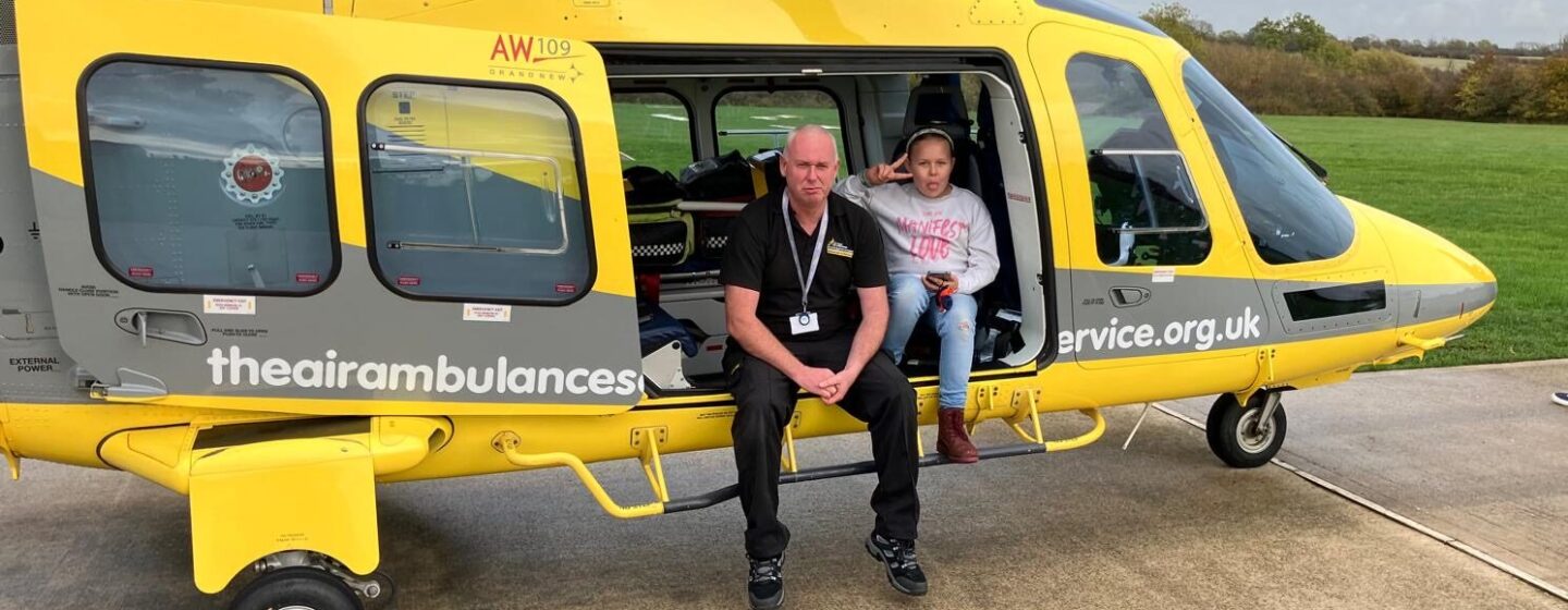 Destiny sittiing in our helicopter, on a base visit, doing a peace sign.