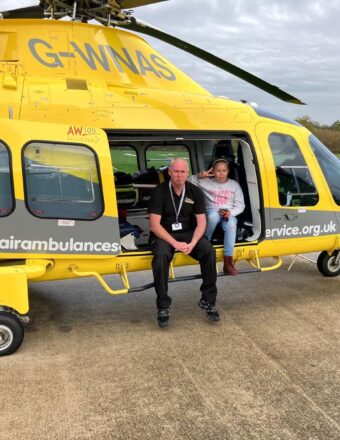 Destiny sittiing in our helicopter, on a base visit, doing a peace sign.