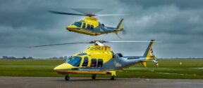 Two TAAS helicopters, one on the ground and one in flight