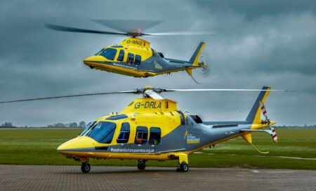 Two TAAS helicopters, one on the ground and one in flight