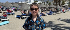 Fred on holiday, at the beach, wearing a Hawaiian shirt