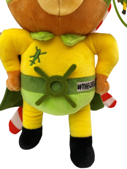 Front facing photograph of stuffed bear plush, Blade - our TCAA mascot. He's wearing a yellow top, and a green cape and mask. On his back are helicopter blades. Close up image of his green belt, which has helicopter blades for a buckle.