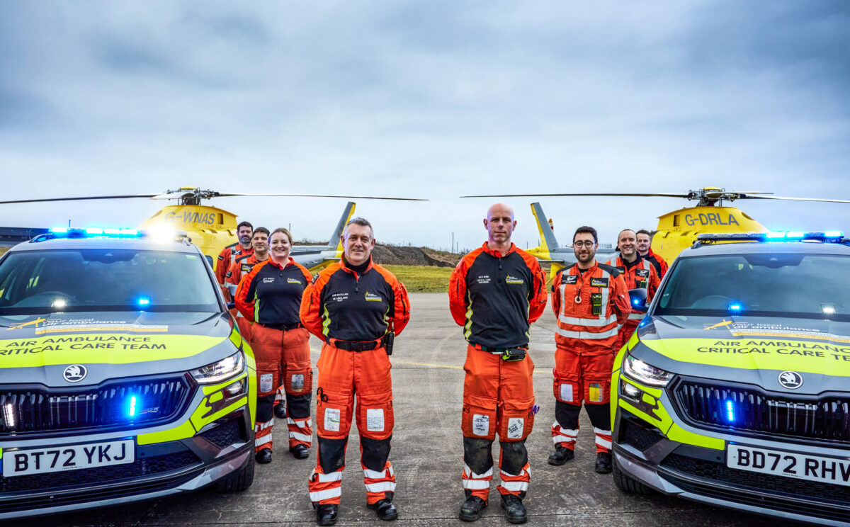 50,000 missions for Your Local Air Ambulance. Groupd shot of Pilots, Doctors and paramedics in front the the helicopters and critical care cars
