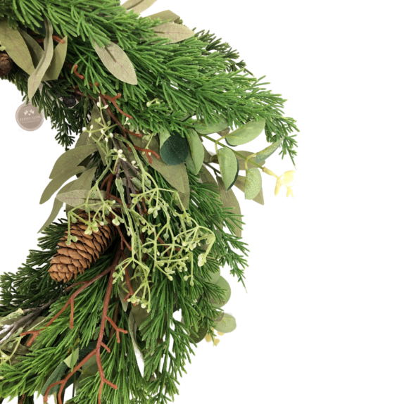Close up of green foliage and fircone wreath