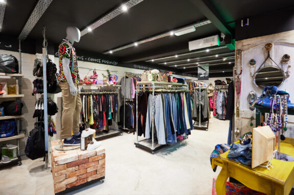 Image of the interior of our Store of the Future in West Bridgford. There are multiple rails of clothes and a mannequin dressed in fashionable clothes.