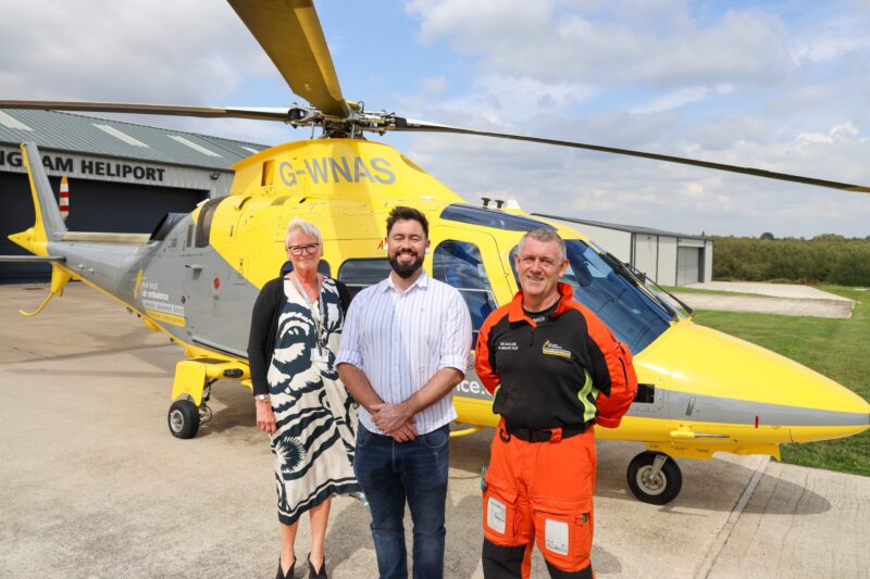 Left to right: CEO Peta Wilkinson, Adam Thompson MP and Pilot John McCallion in front of an air ambulance.