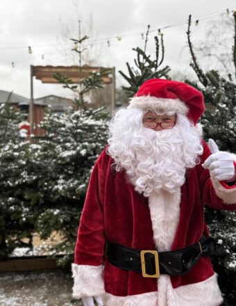 Roger dressed up as Santa with a thumbs up