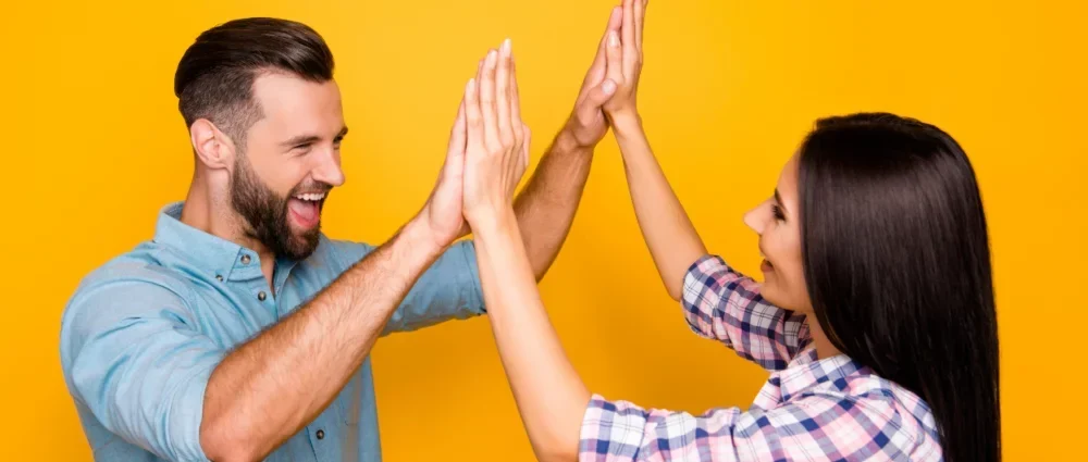 a man and a woman high fiving