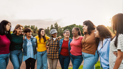 Happy multigenerational group of women with different ages and ethnicities having fun in a public park - People diversity concept